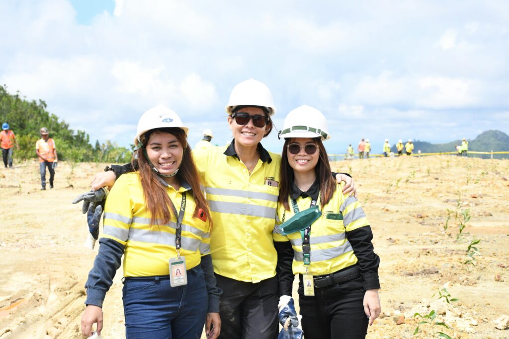 Smiling construction team in helmets posing on site in sunny Cebu City, Philippines.
